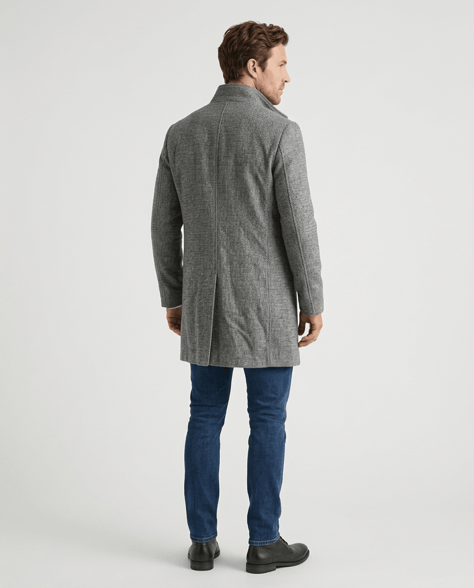 Back view of the light gray overcoat worn with blue jeans and dark shoes