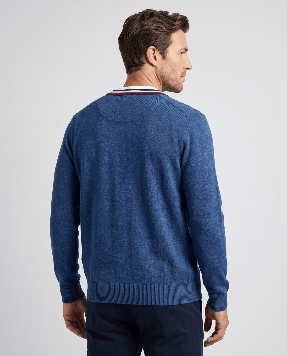 Back view of the deep blue fine-knit cardigan with striped collar trim