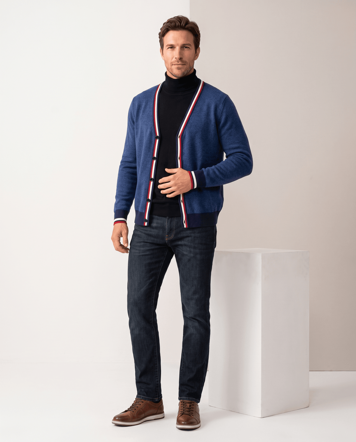 Full-length view of the deep blue cardigan over a black turtleneck with jeans