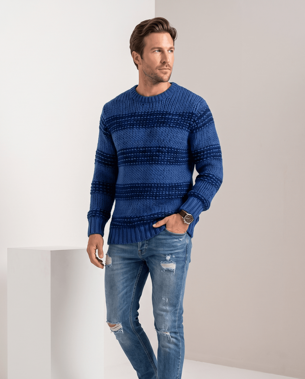 Model in blue striped chunky knit sweater with distressed jeans