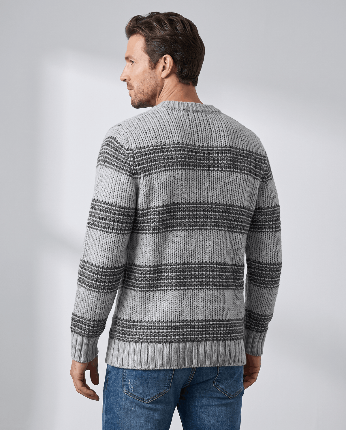 Back view of gray striped crew neck pullover with ribbed hem