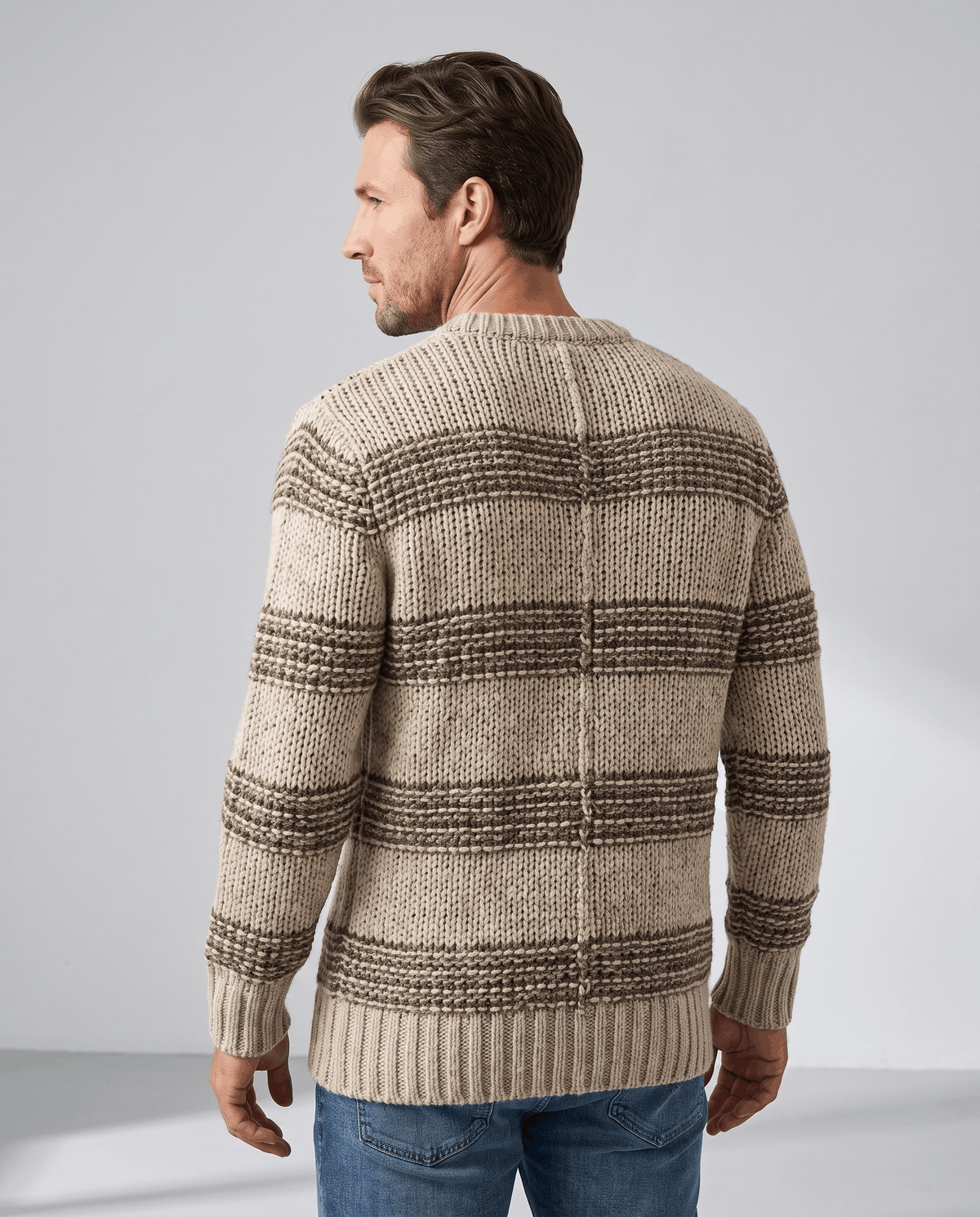 Back view of khaki striped crew neck sweater with ribbed hem