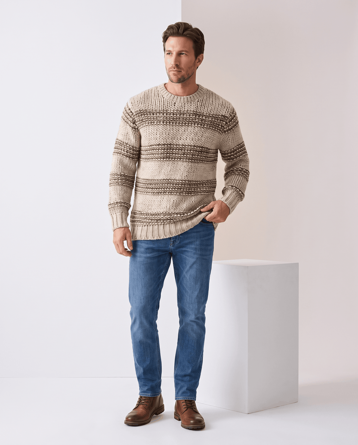 Full-length khaki striped sweater outfit with blue jeans and brown boots