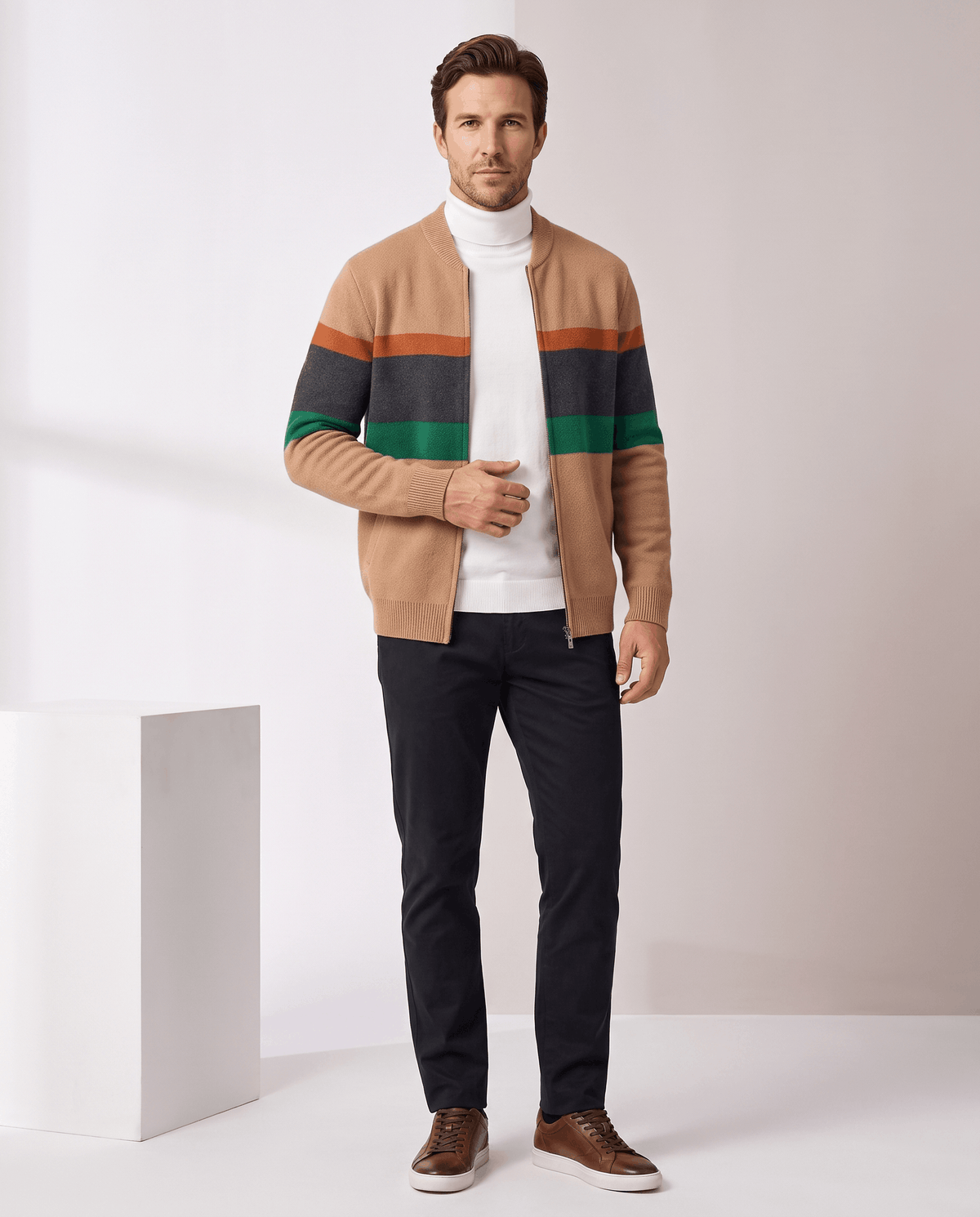 Full-length view of the beige cardigan with cream turtleneck, black trousers and brown shoes