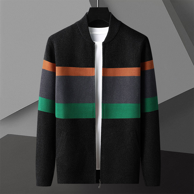 Black and green striped zip cardigan hanging open on a hanger against a gray backdrop