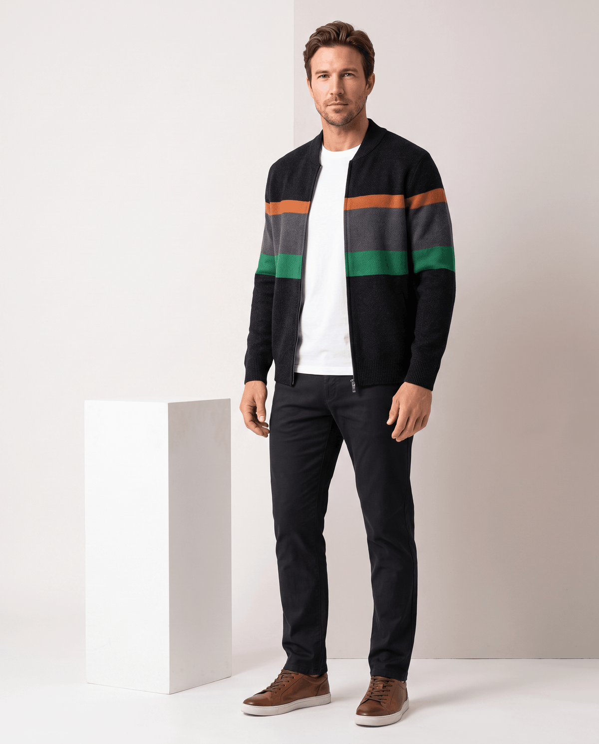 Full-length view of the black and green cardigan worn open over a white tee and dark trousers