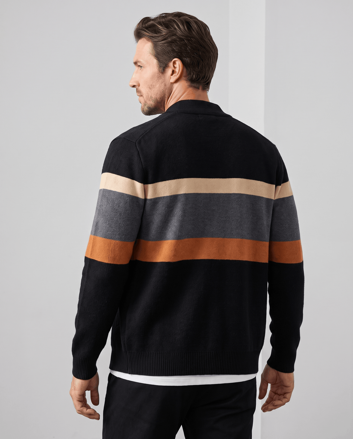 Back view of the black and orange cardigan with cream, gray and orange stripes