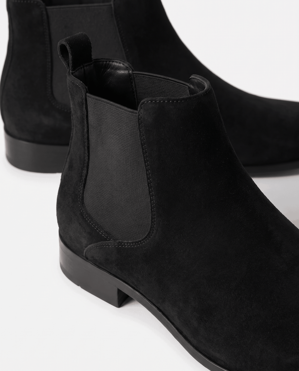 Close-up of black suede and elastic side panel on a Chelsea boot