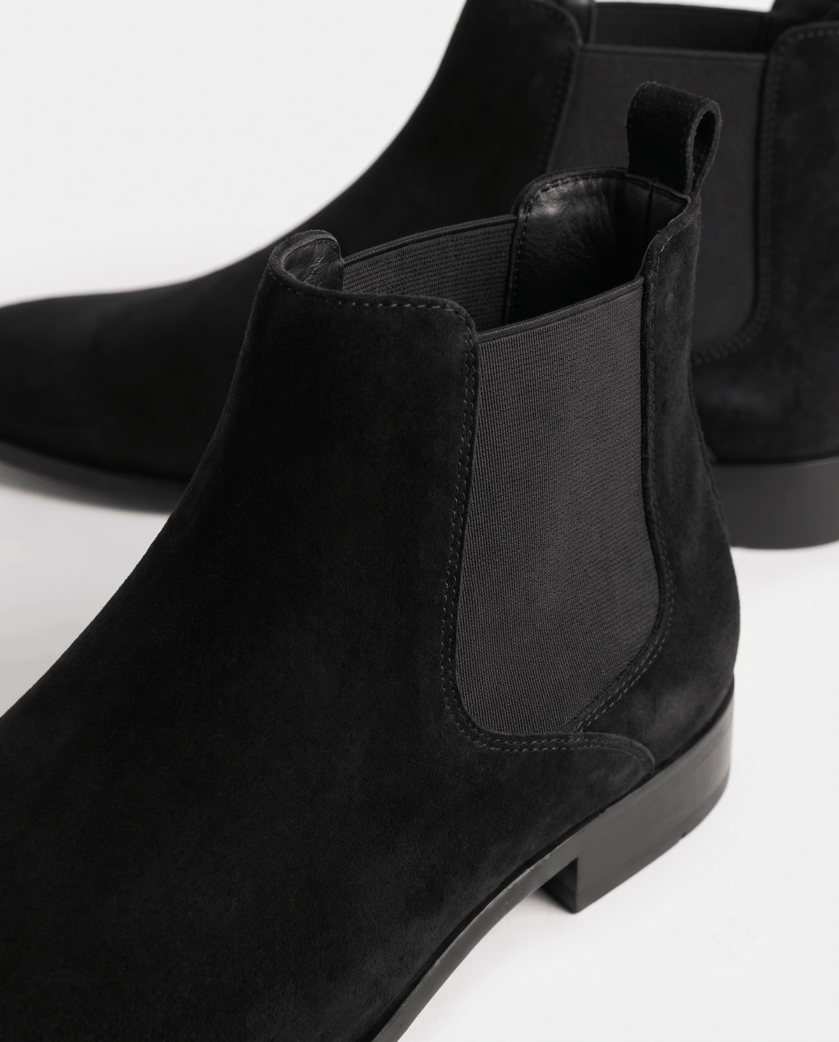 Black suede boot detail showing the elastic gusset and slim heel