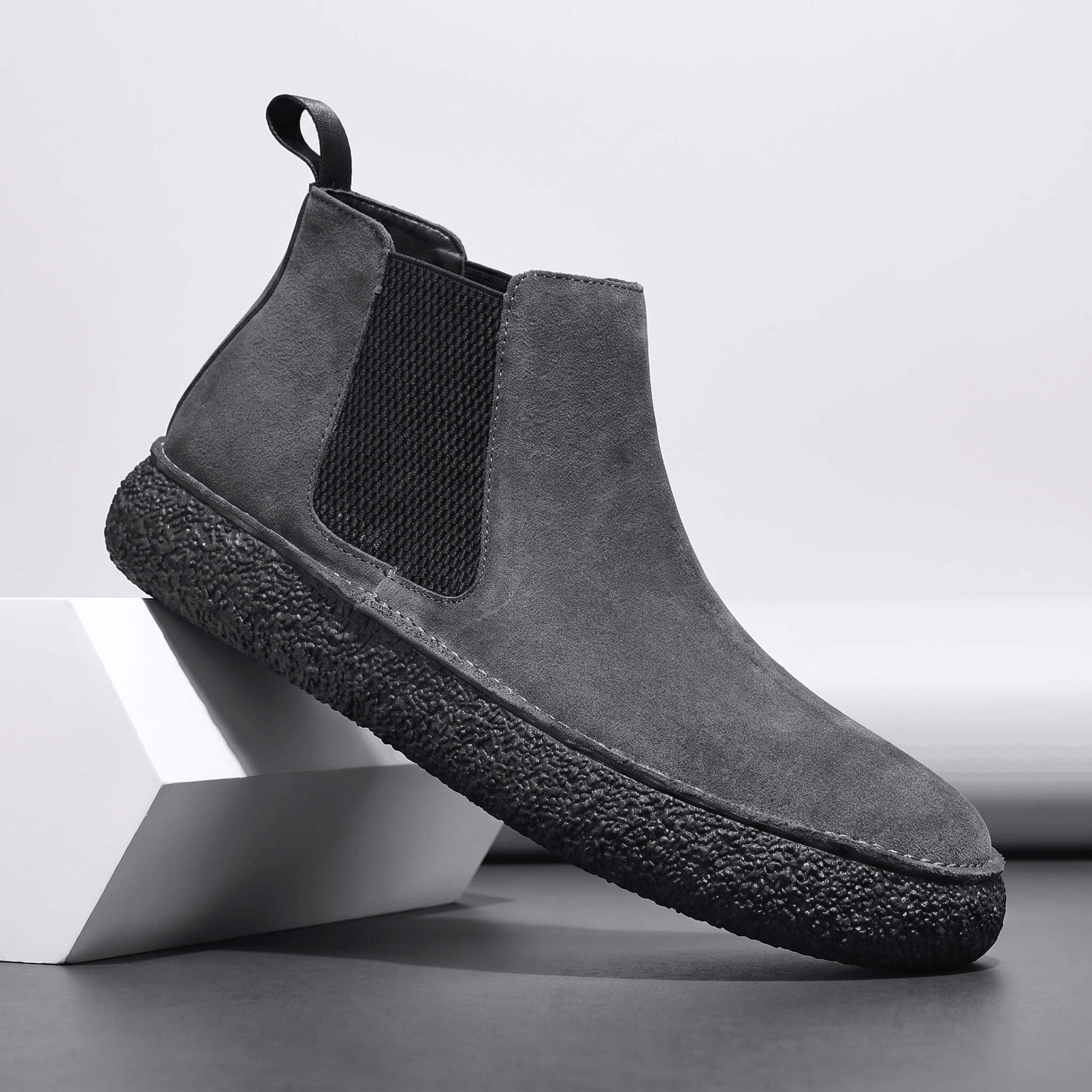Gray suede Chelsea boot with elastic side panel, pull tab and thick speckled crepe sole.