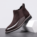 Dark brown suede Chelsea boot with polished leather toe cap, elastic side gore, welt stitching, and a stacked heel.