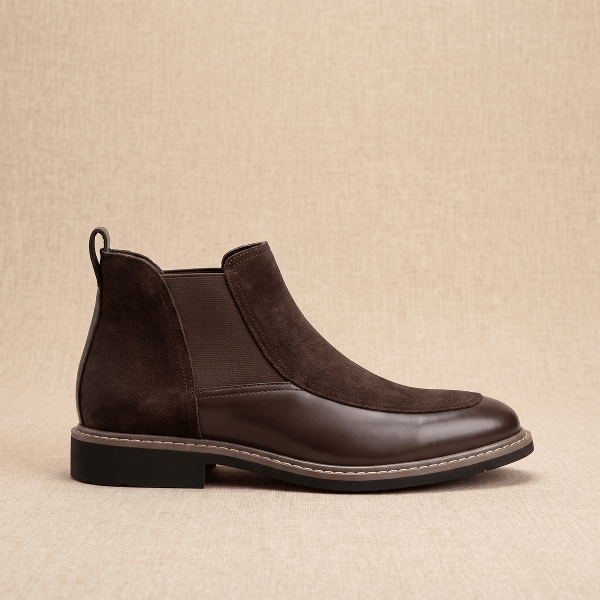 Dark brown Chelsea boot featuring a polished leather toe cap, suede upper, elastic side gore, and welt stitching.