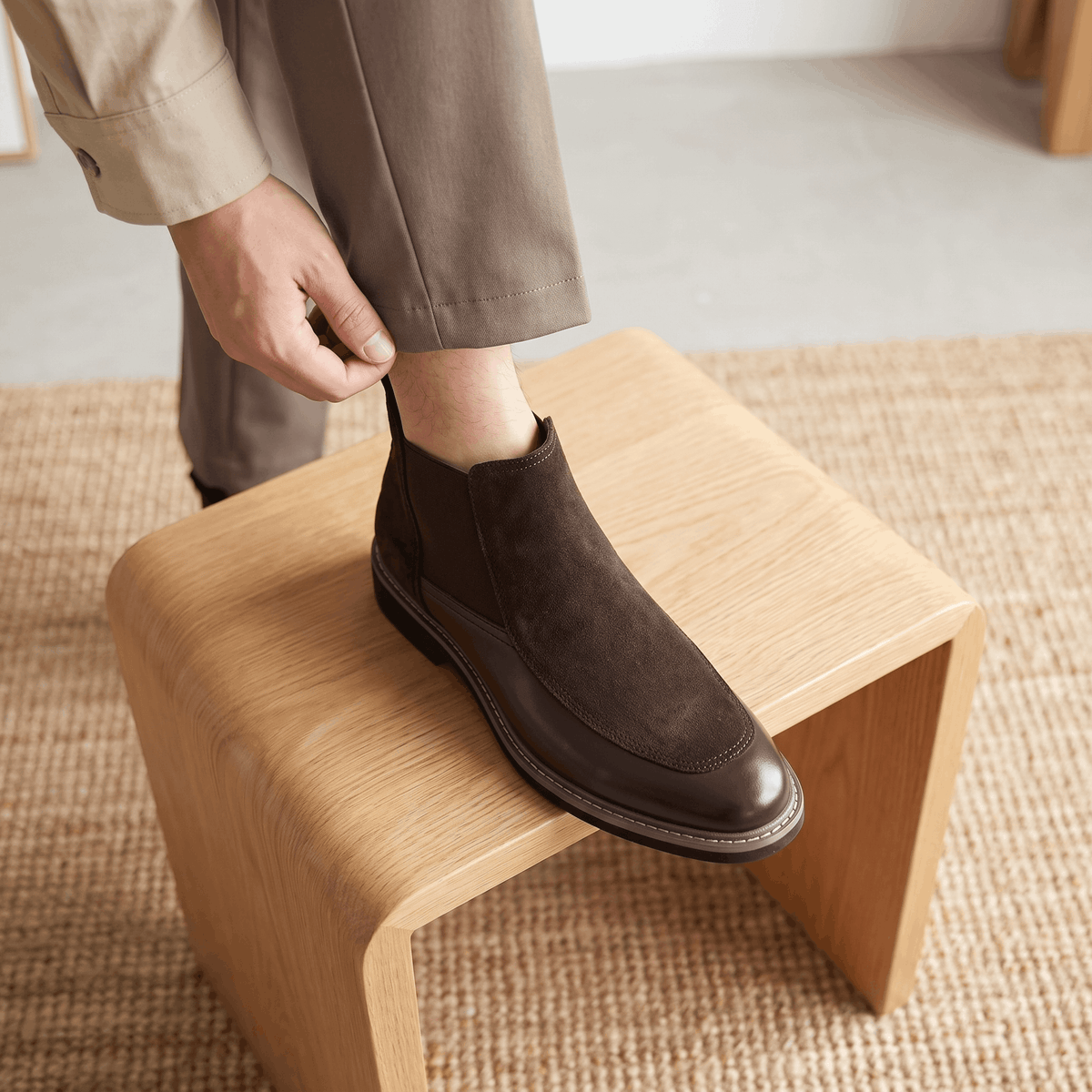 Dark brown suede Chelsea boot with a polished leather toe cap, elastic side gore, and welt stitching on a stacked heel.