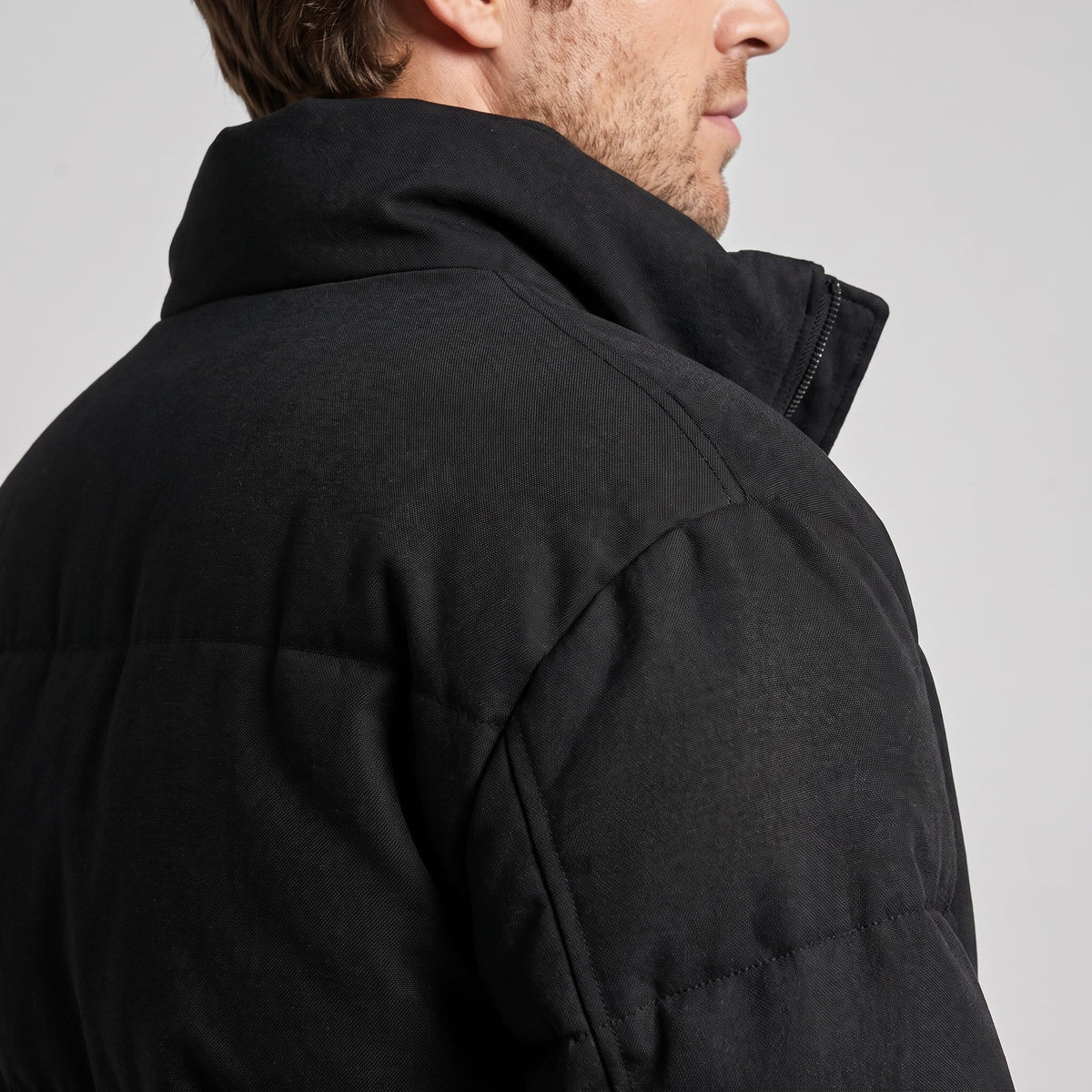 Close collar and shoulder detail in black, showing the matte napped finish