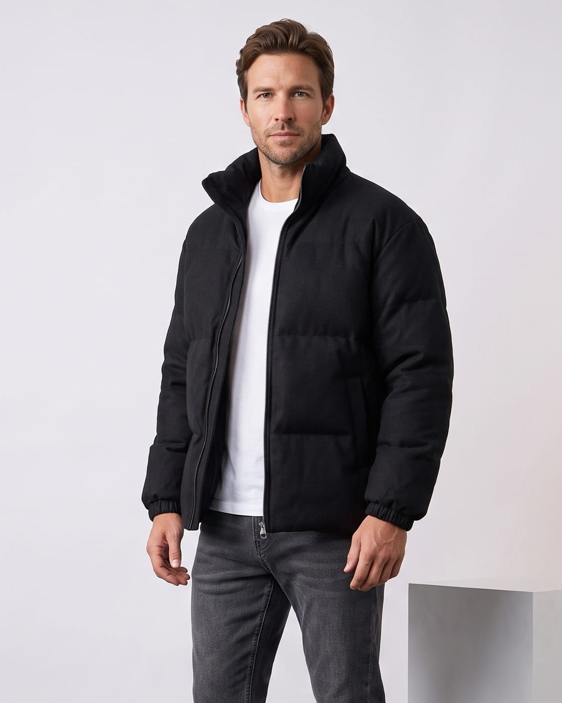 Black colorway worn zipped with the stand collar upright at the neck