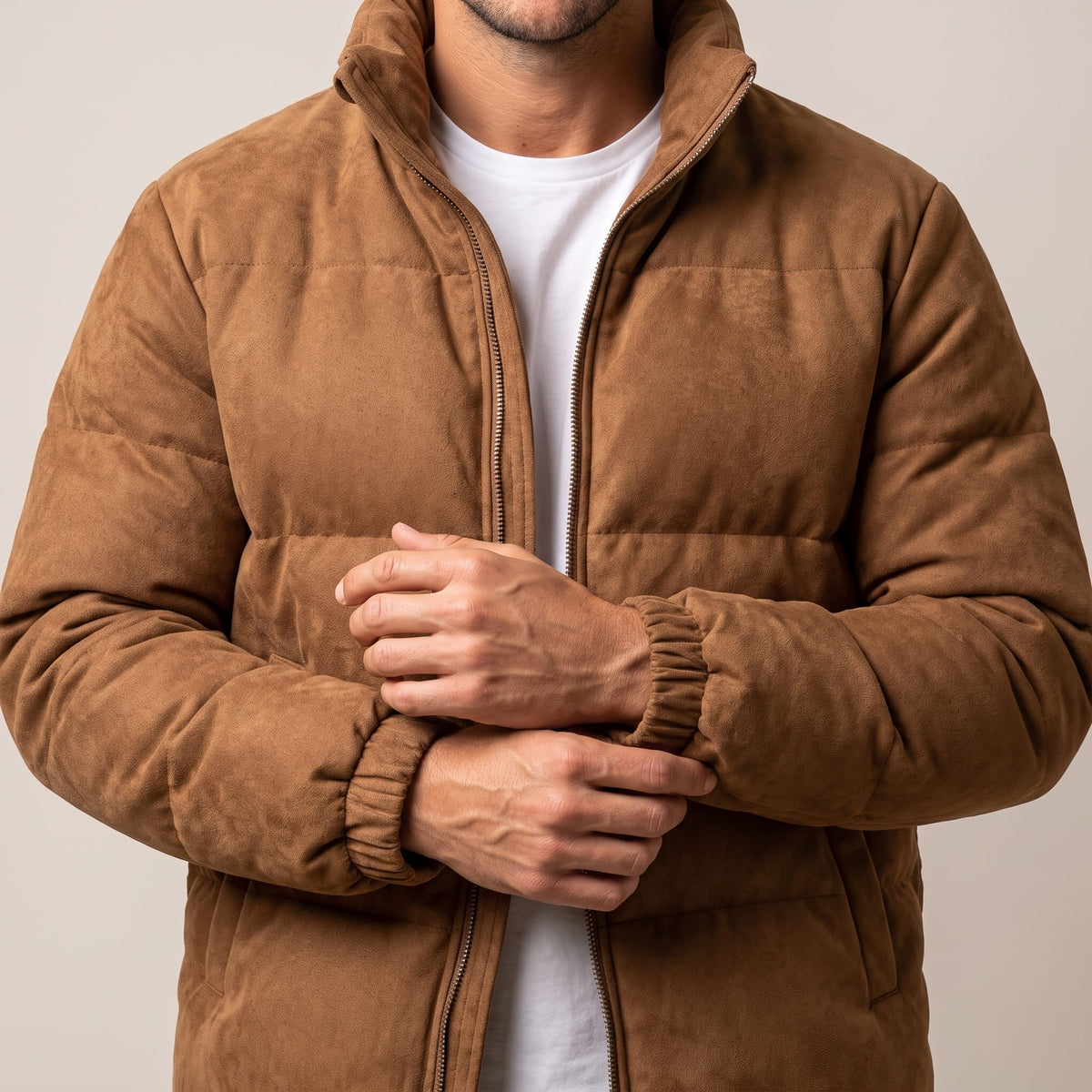 Close view of the elasticated cuff gathering at the wrist on the brown jacket