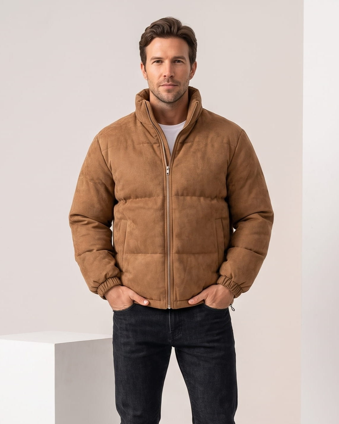 Man wearing brown suede-look puffer jacket with tall stand collar, hands in pockets