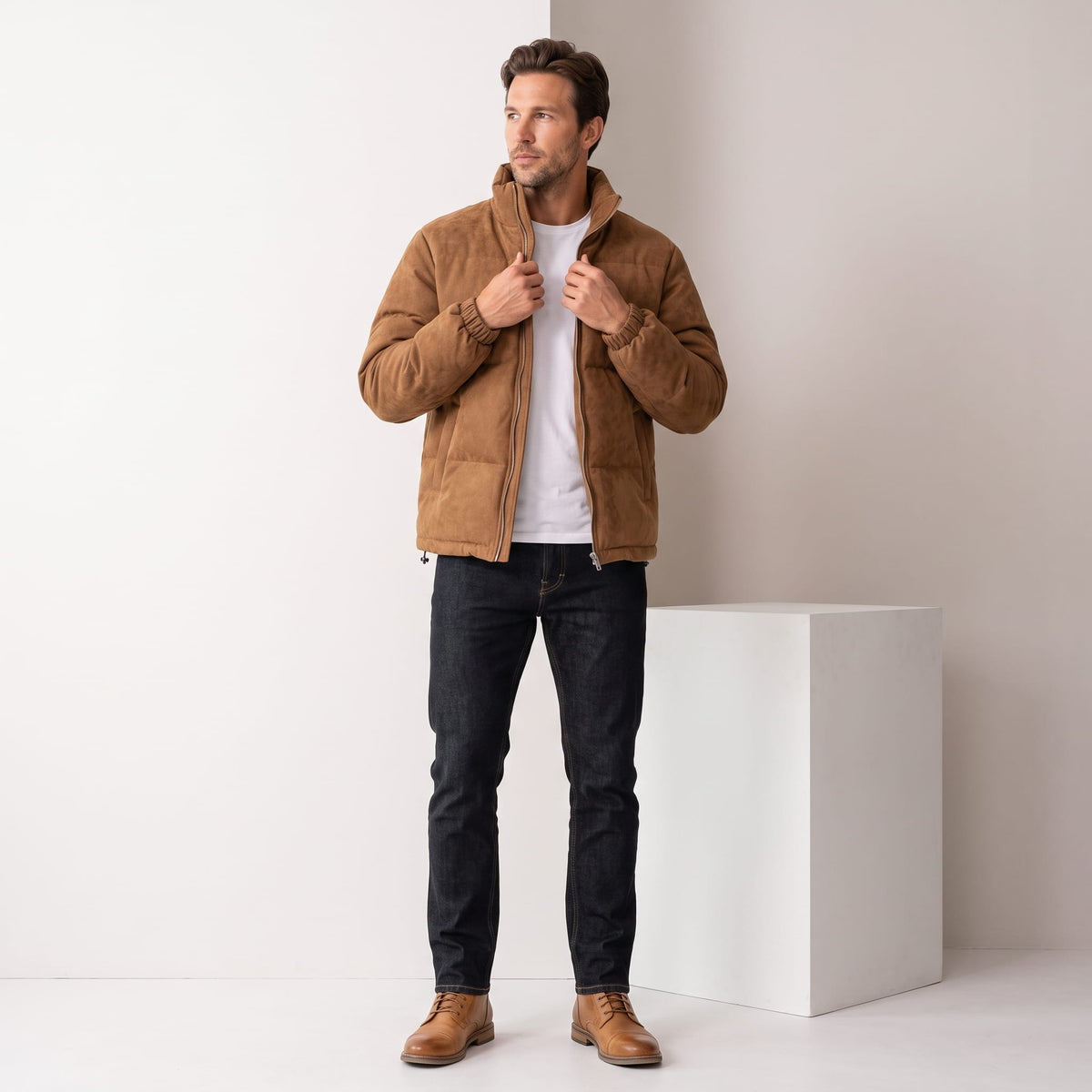 Brown jacket styled full-length with dark jeans and tan leather boots