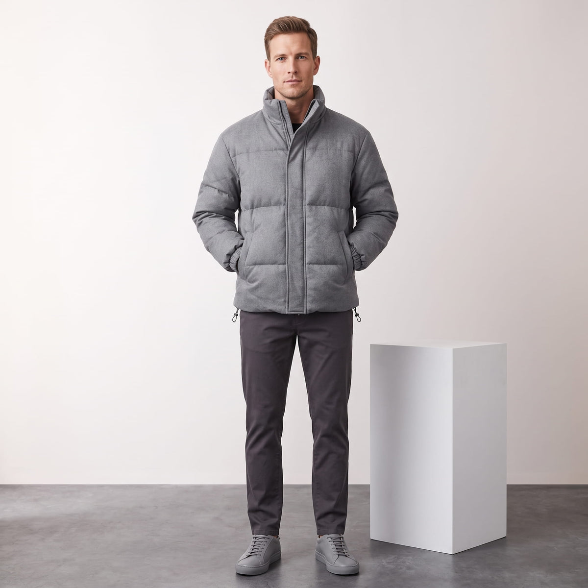 Gray jacket styled full-length with charcoal trousers and grey boots