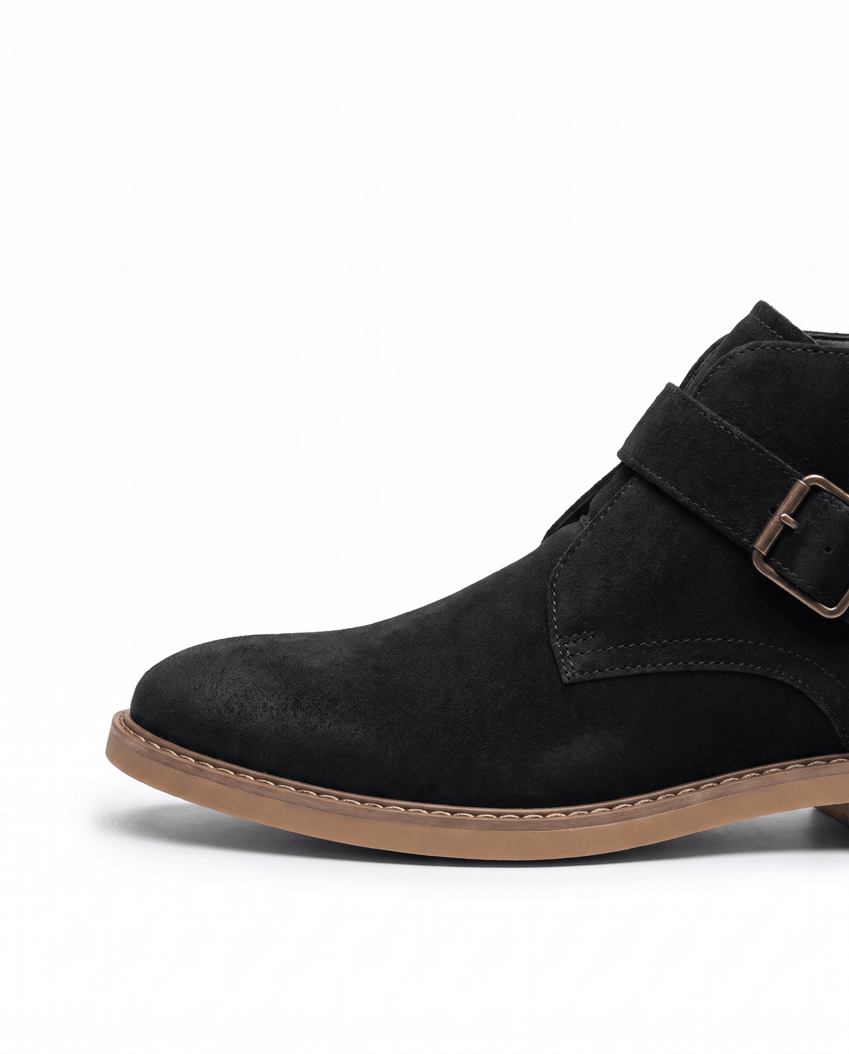 Black suede boot toe and side view with buckle strap and tan sole on white