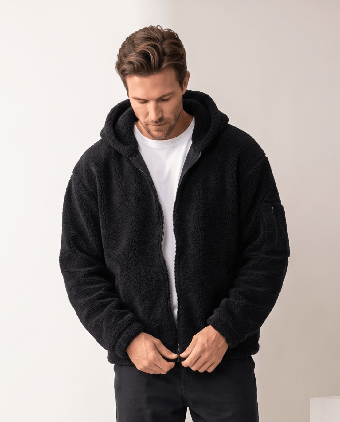 Black fleece jacket being zipped up over a white tee