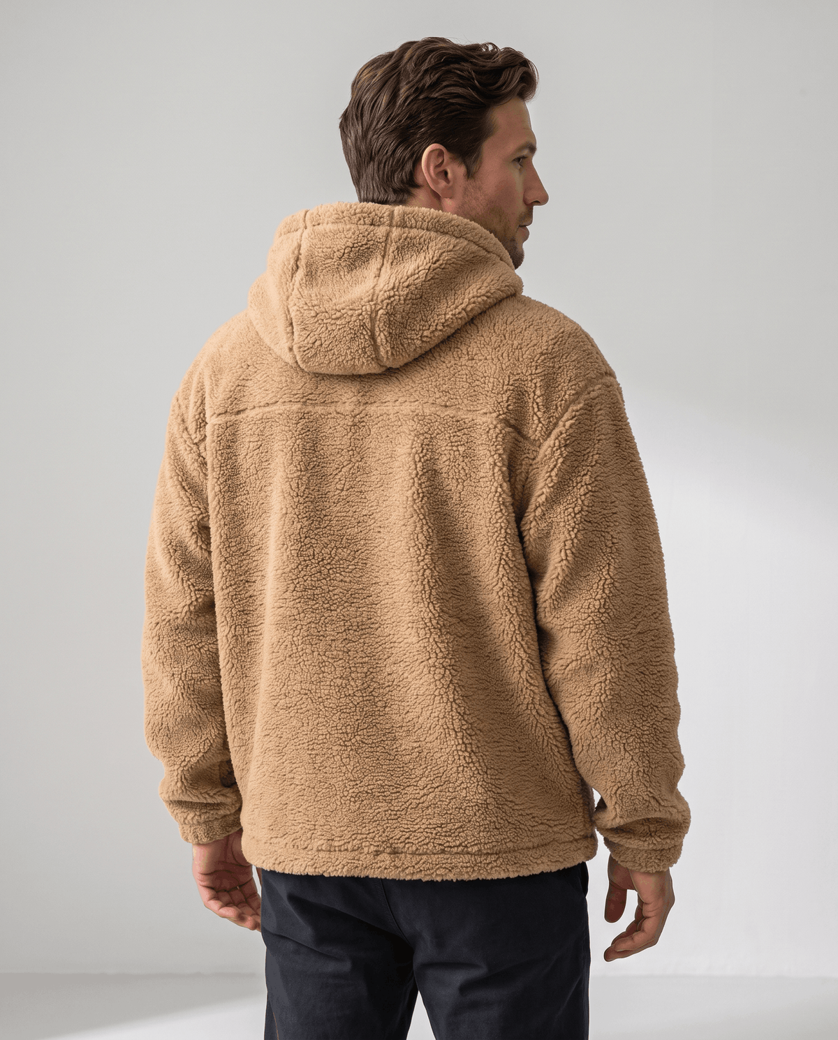 Back view of khaki full-zip jacket showing hood and relaxed fit