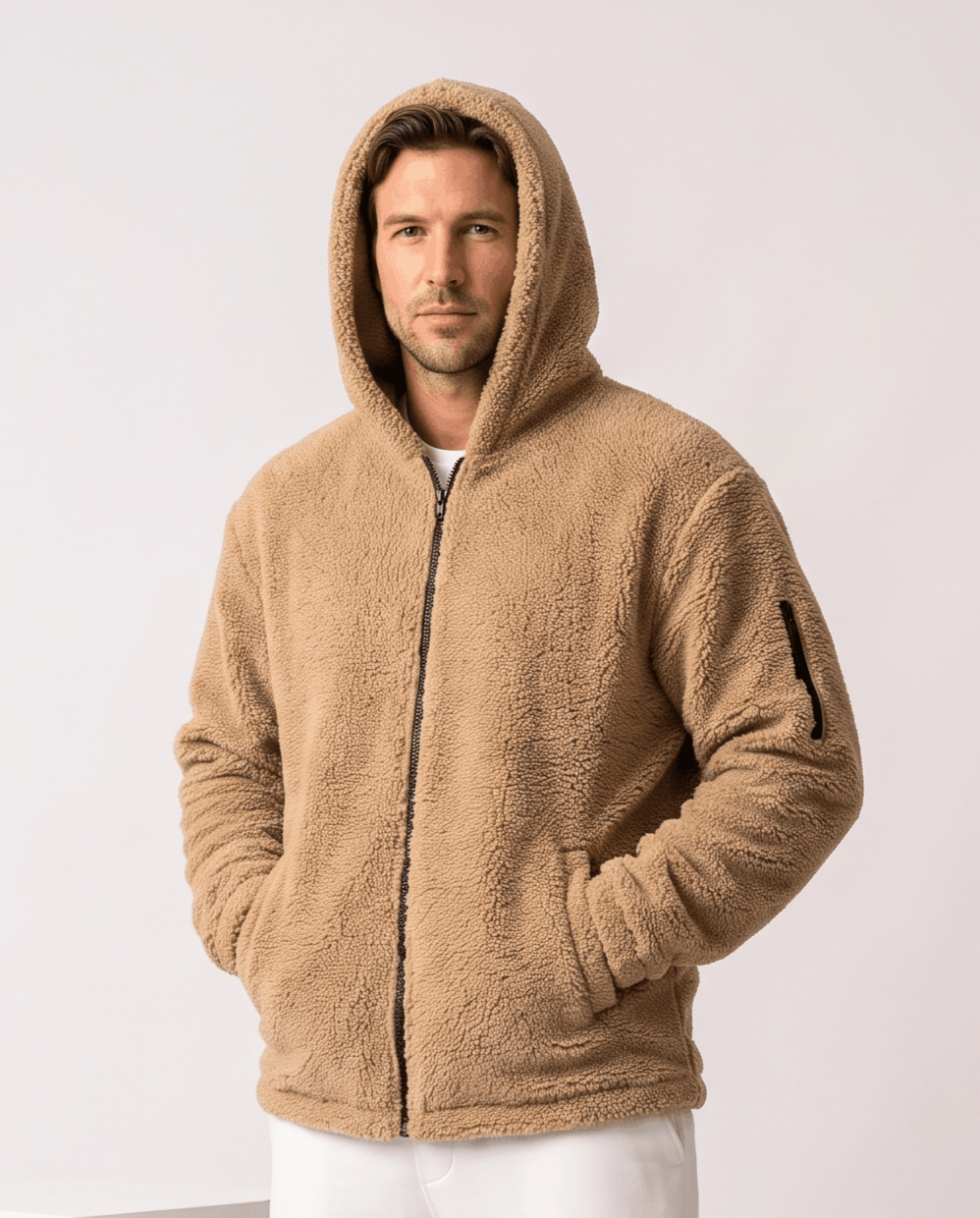 Men's teddy fleece hooded jacket in khaki worn with hood up and white pants