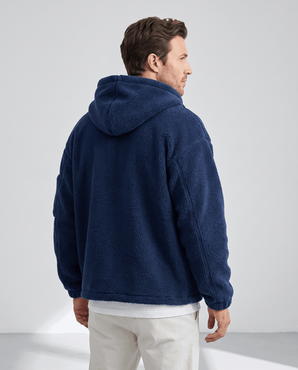 Back view of navy hooded jacket showing relaxed loose fit