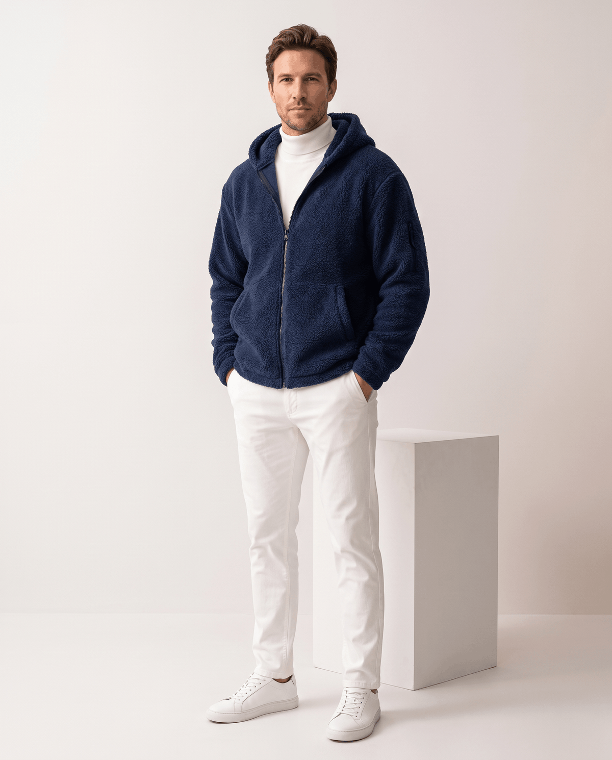 Full-length navy outfit styled with white pants and white sneakers