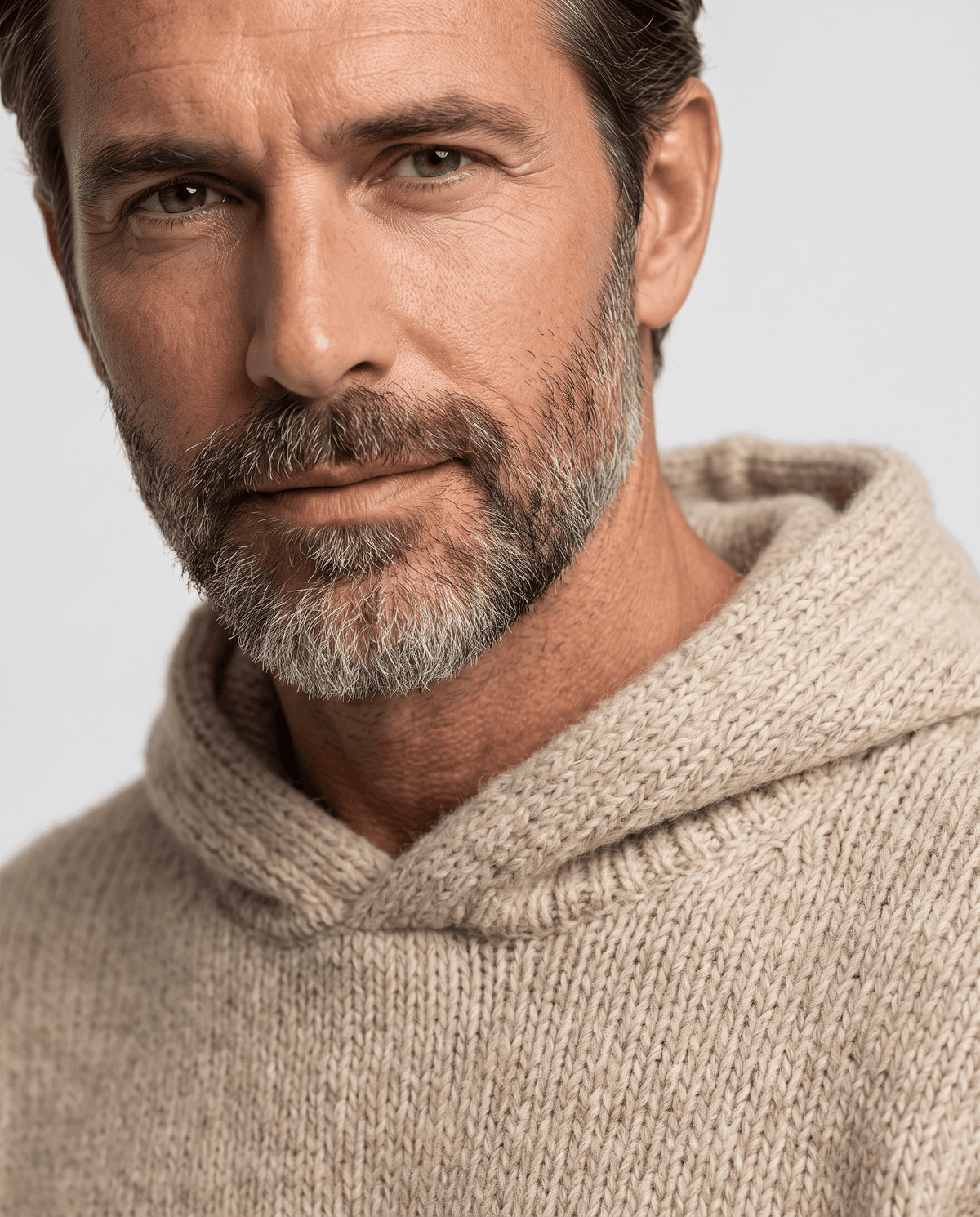 Close-up of the beige knit hood and neckline framing the wearer's face