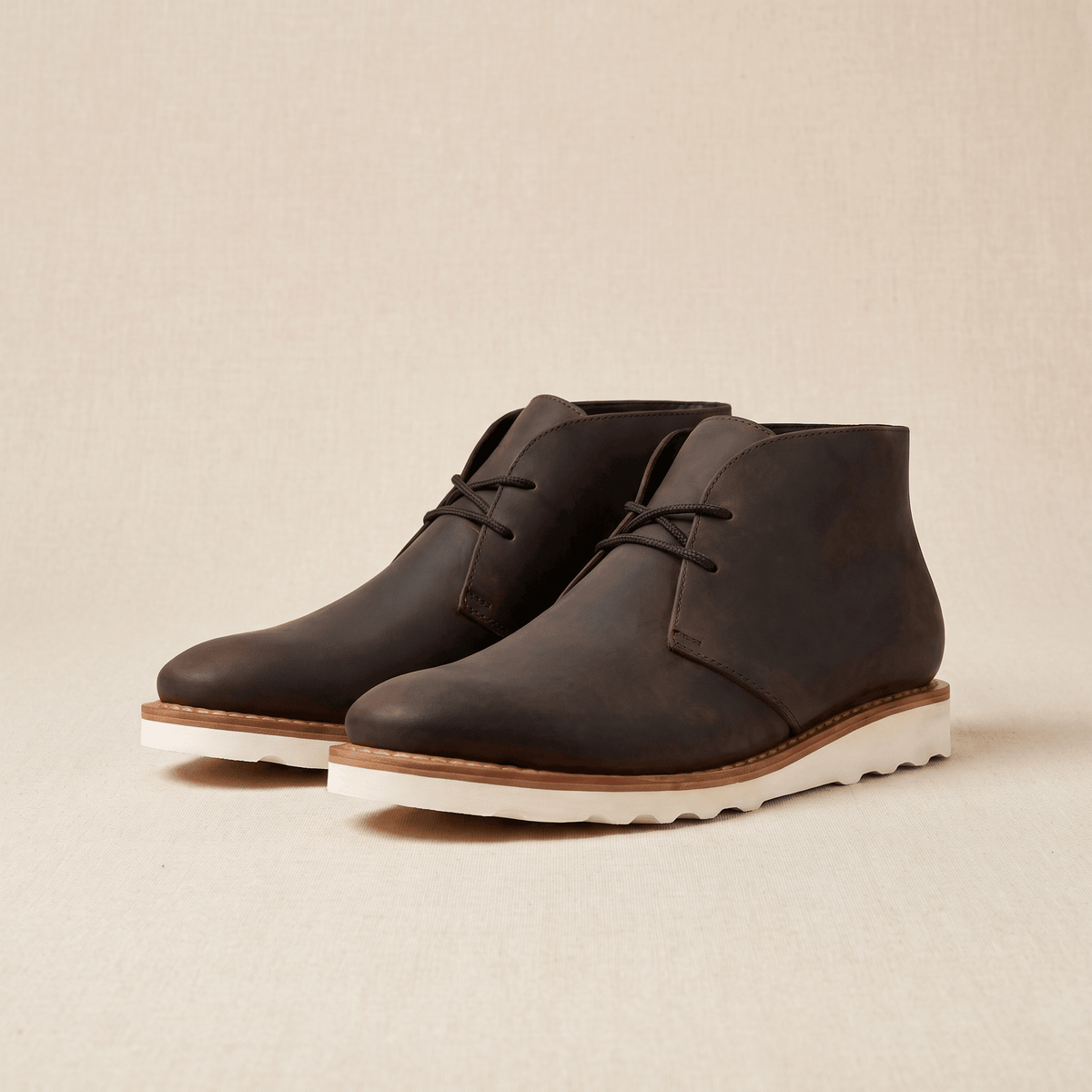 Matte chukka boot with a short lace throat and a raised scalloped sole.