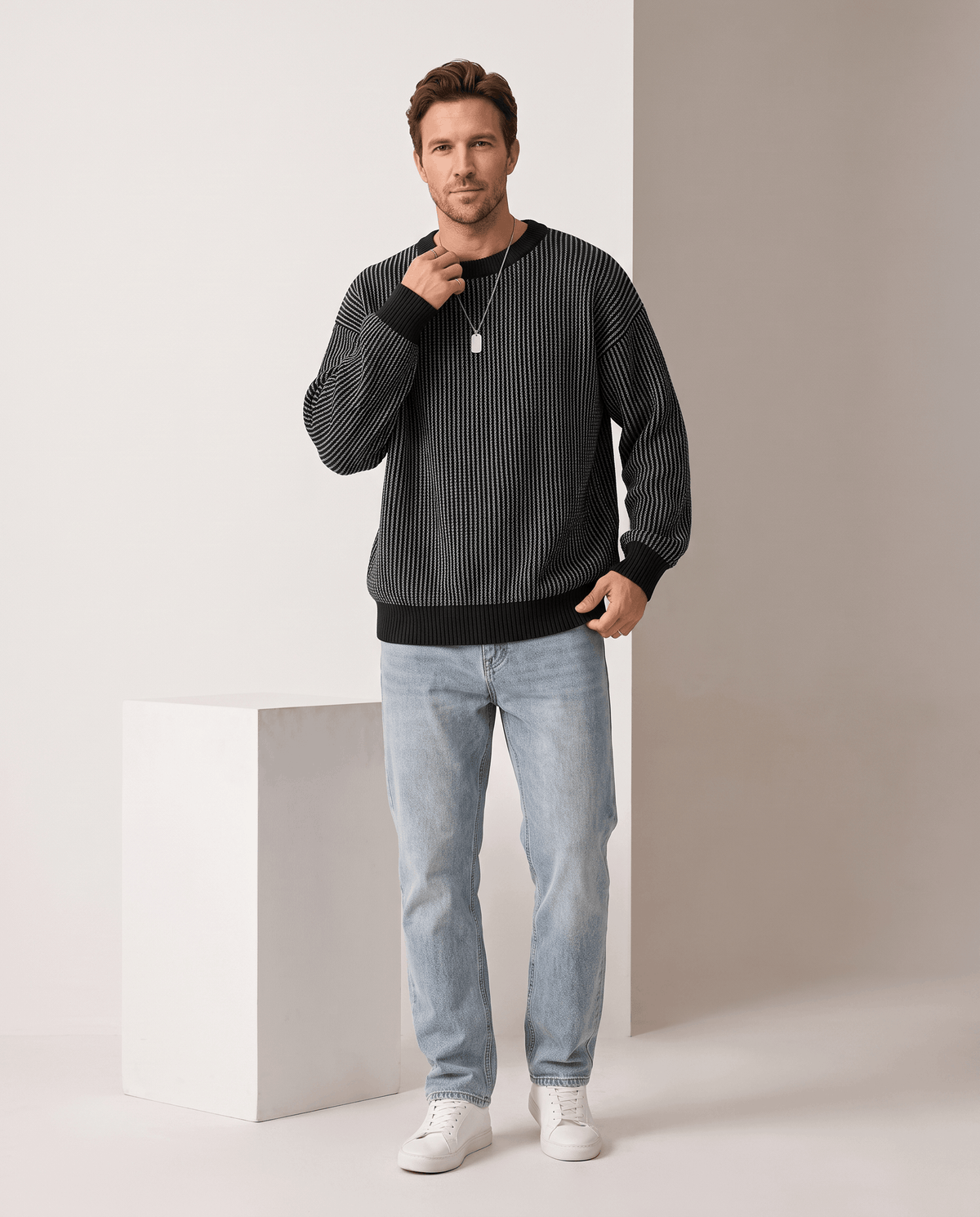 Full-length black striped sweater outfit with light jeans and sneakers
