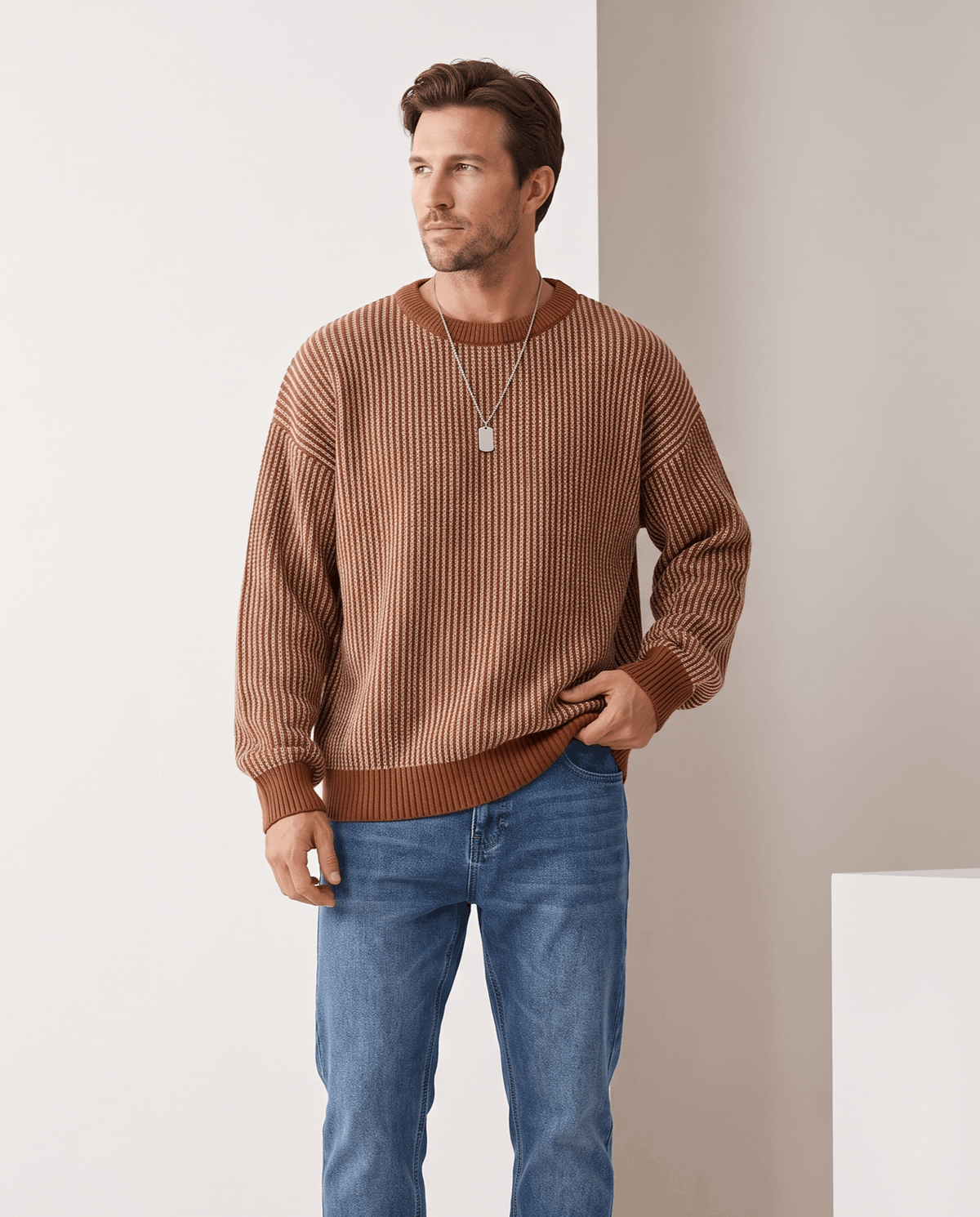 Model in brown two-tone striped knit sweater with light blue jeans
