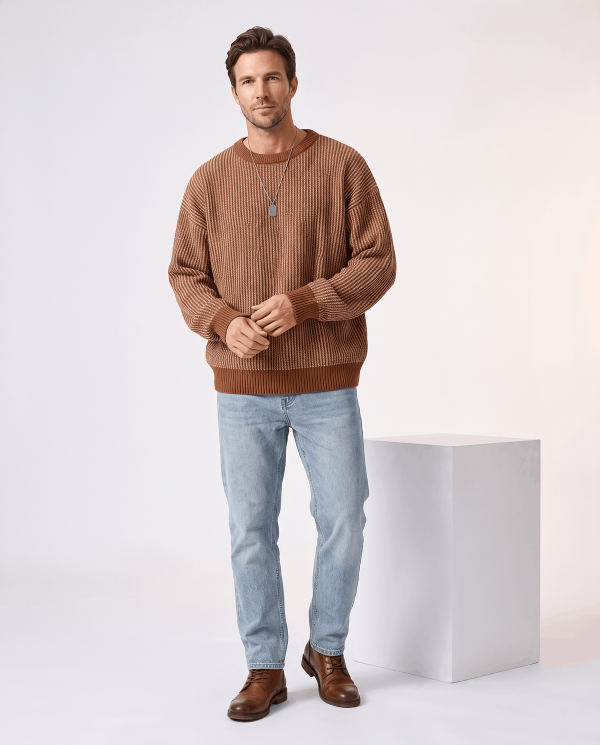 Full-length brown striped sweater outfit with light jeans and brown boots