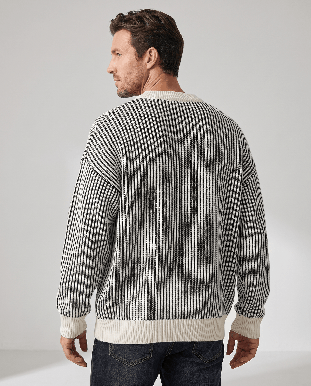 Back view of black and cream striped pullover with cream cuffs