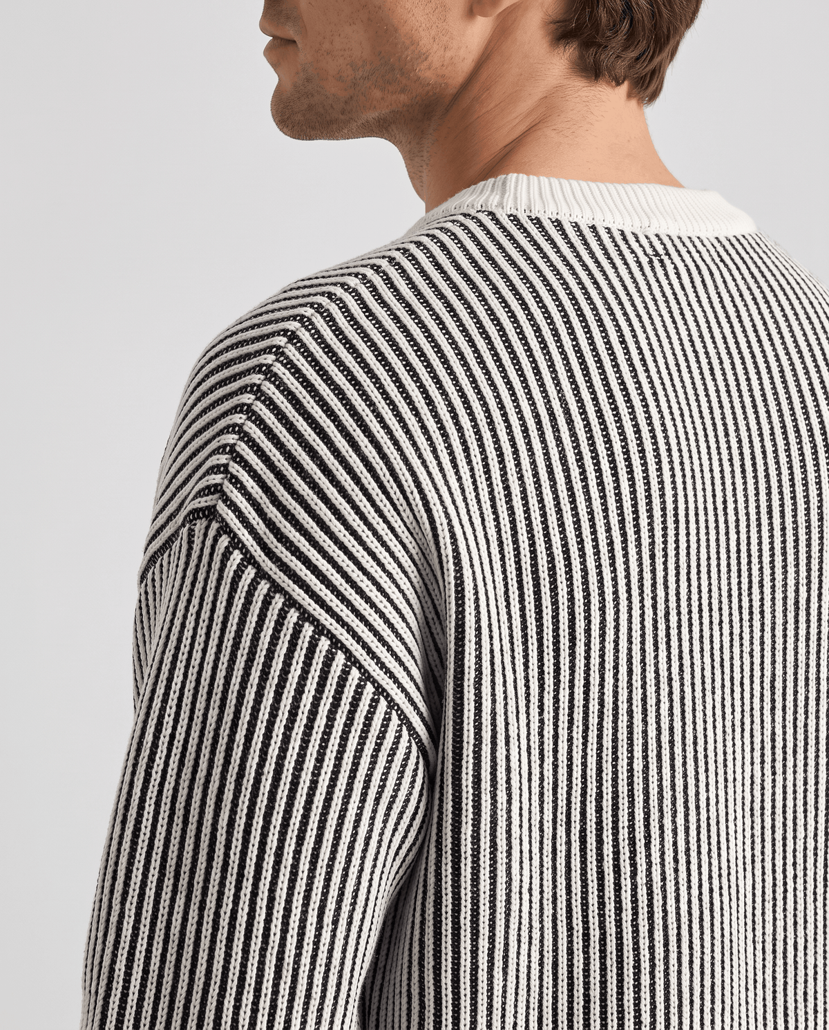 Side close-up of black and cream vertical stripes at the shoulder