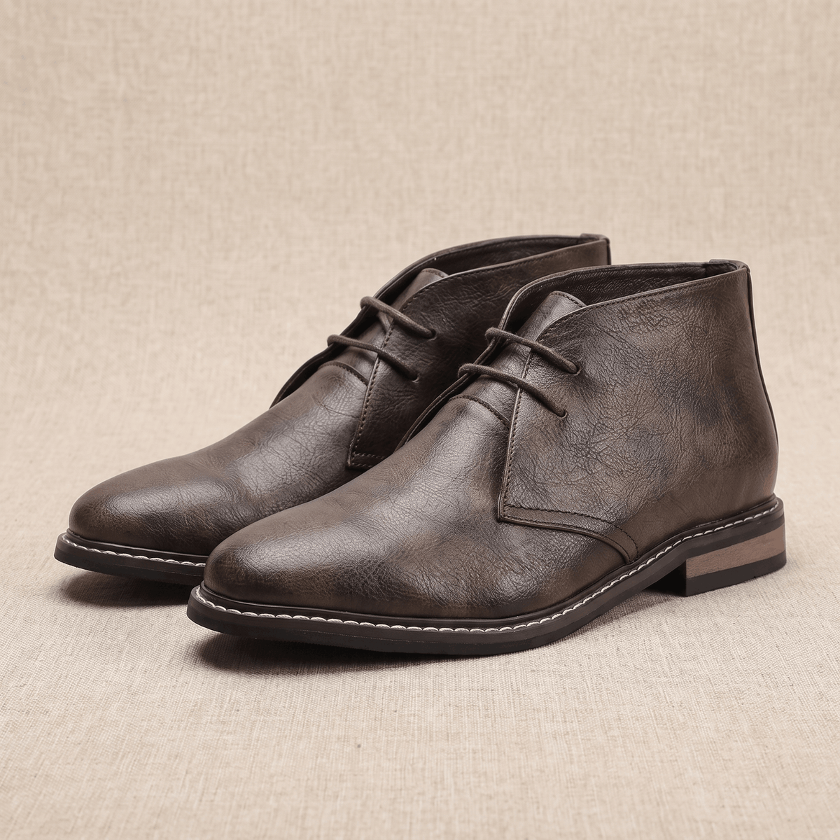 Pair of brown vegan leather chukka boots displayed on a neutral background.