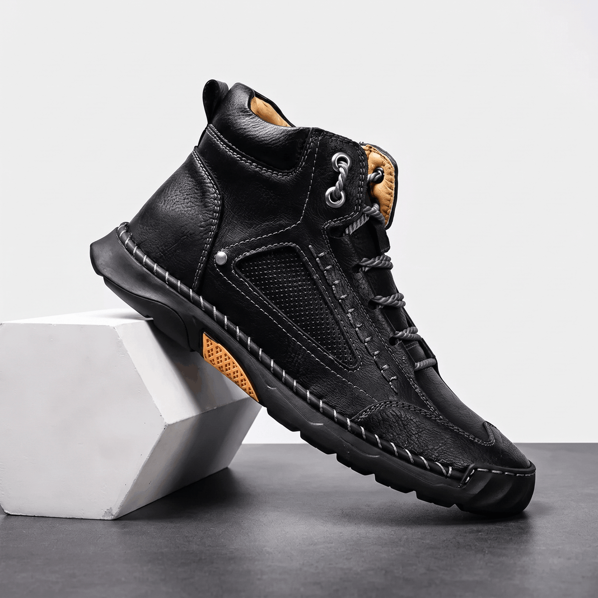 Black vegan leather ankle hiking boot with a wide toe box, mesh side panels, contrast stitching, and a rugged lug outsole.