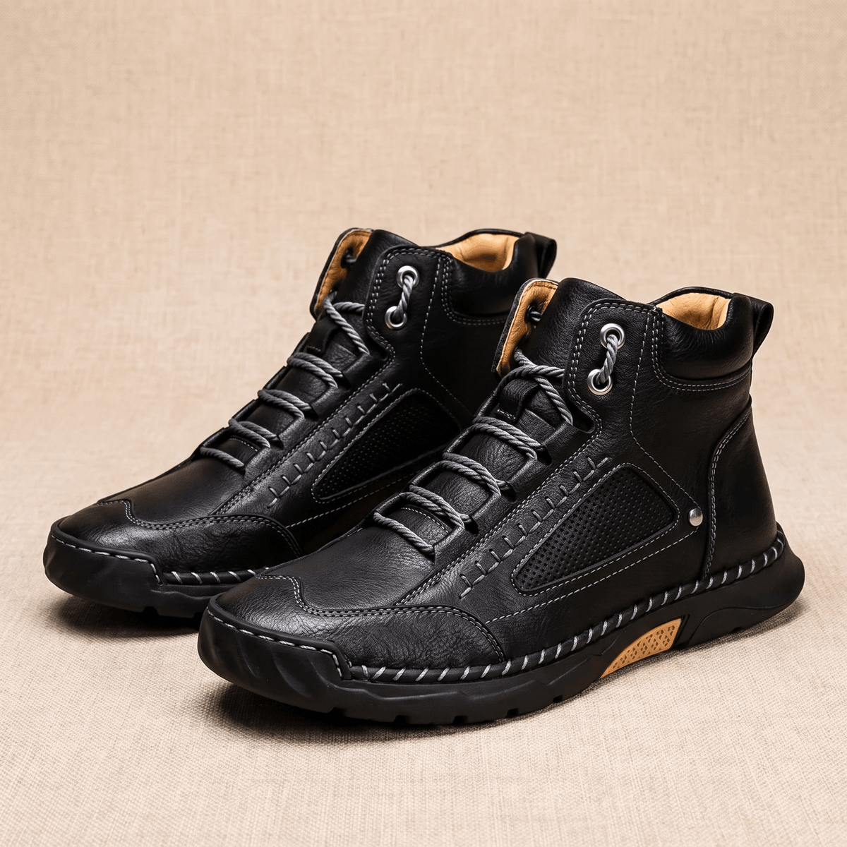 Black vegan leather ankle hiking boots with a wide toe box, mesh side panels, and a durable lug outsole on a neutral background.