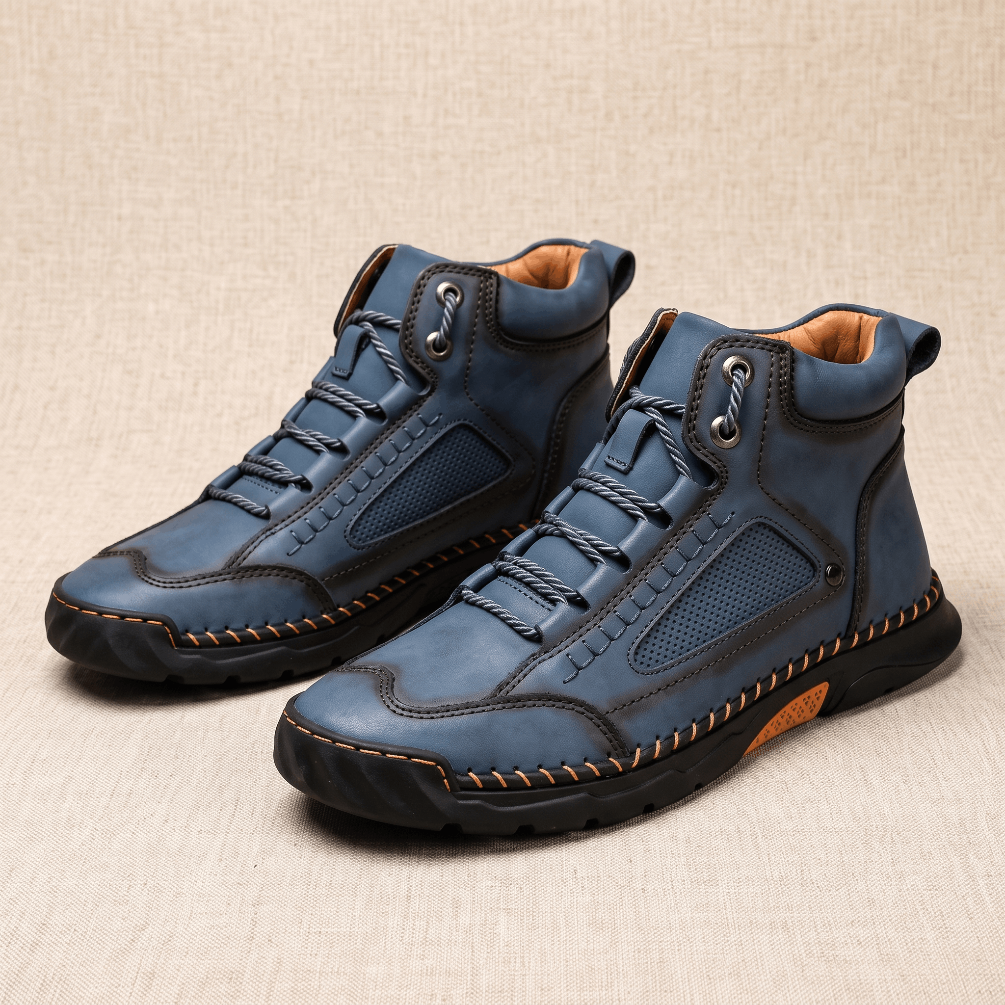 Blue vegan leather hiking boots with a wide toe box, mesh side panels, and a rugged black lug outsole on a neutral background.