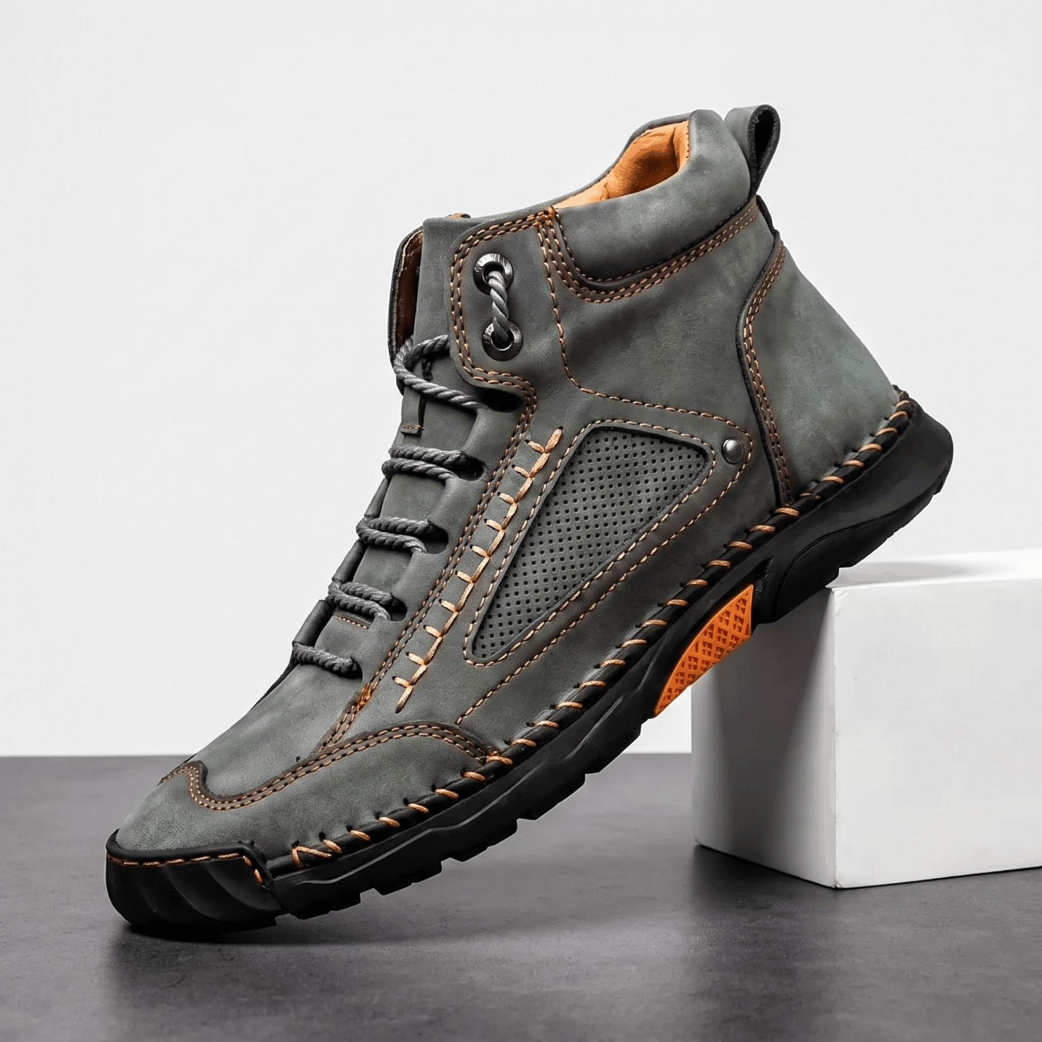 Gray vegan leather ankle hiking boot with wide toe box, contrast stitching, perforated side panel, and rugged lug outsole.