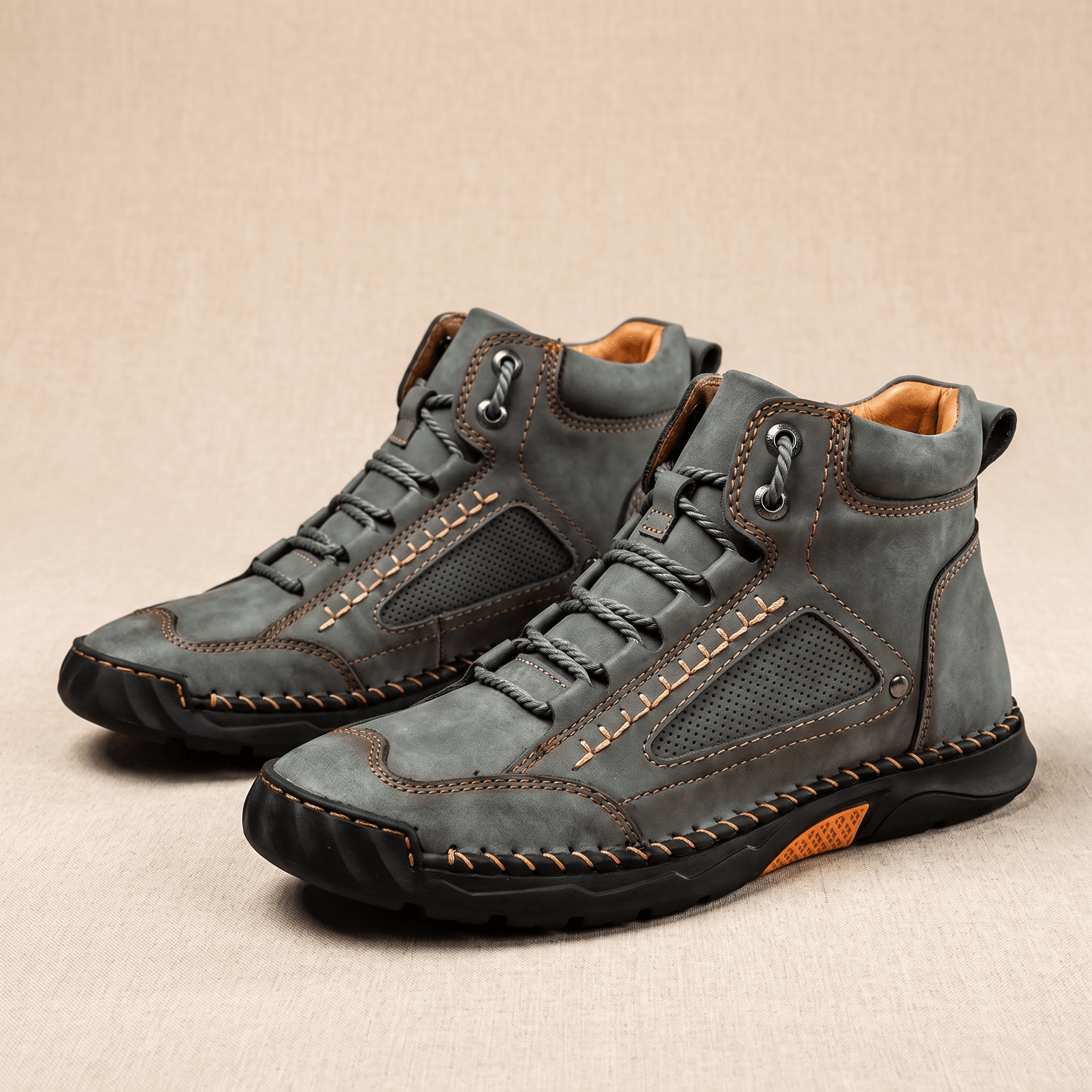 Gray vegan leather hiking boots with wide toe box, perforated side panels, contrast stitching, and a rugged black lug outsole.
