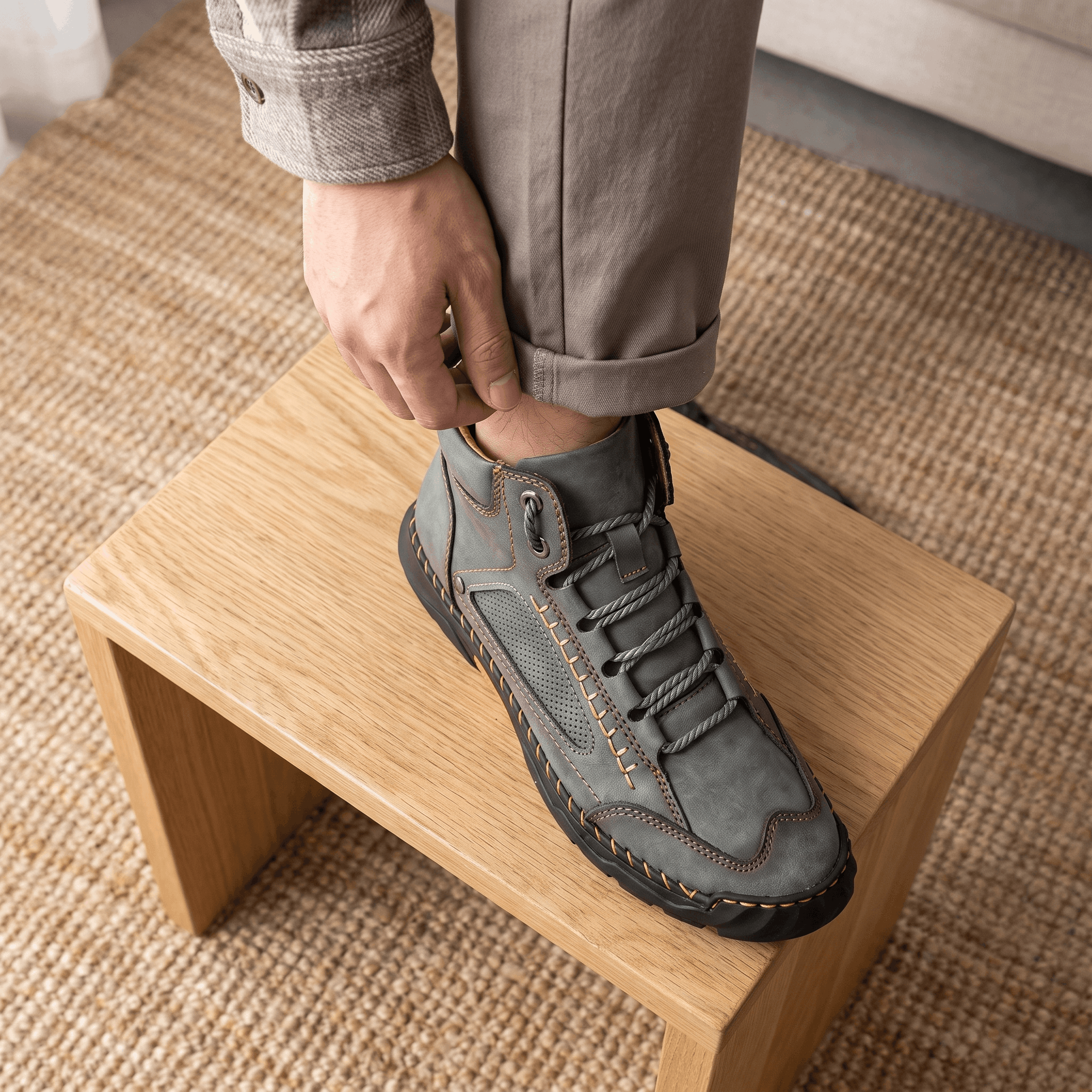 Gray vegan leather hiking boots with wide toe box, lace-up closure, perforated side panels, and rugged lug outsoles.