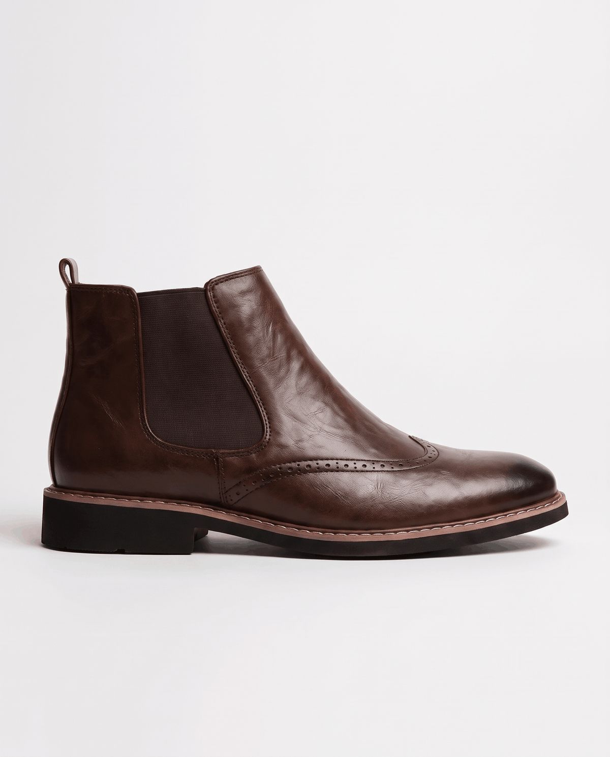 Brown boot in side profile showing the elastic panel, heel pull tab and stitched welt