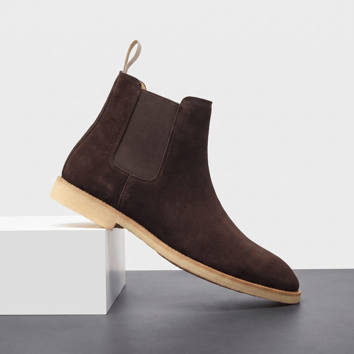Dark brown vegan suede Chelsea boot with elastic side panel, rear pull tab and block heel.