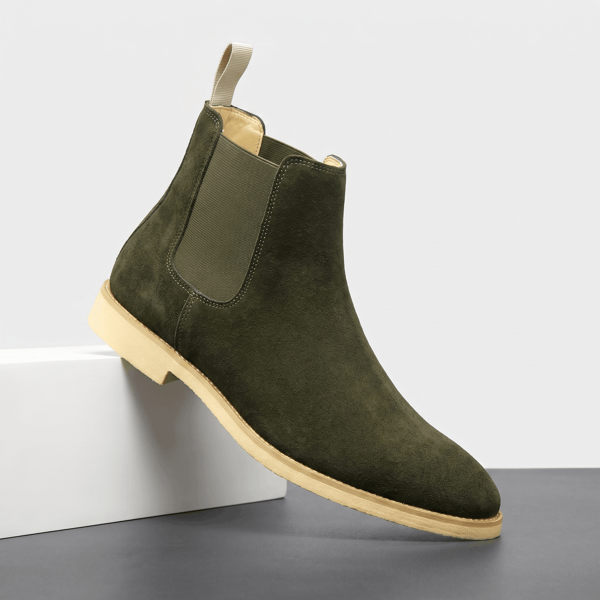 Single dark green vegan suede Chelsea boot with elastic side panel, rear pull tab and block heel.