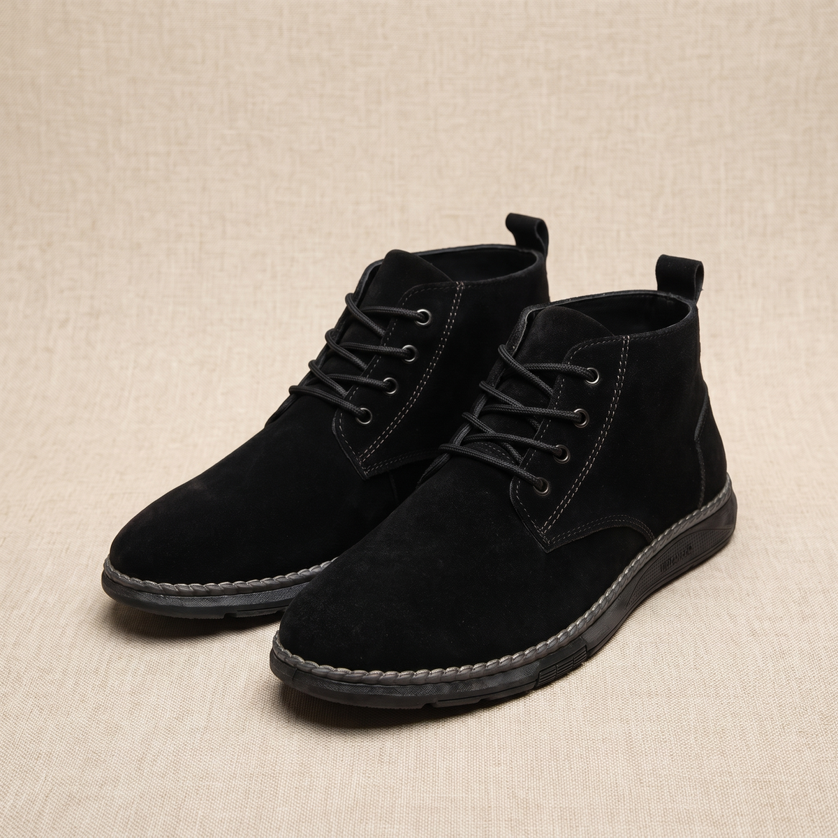 Pair of black vegan suede lace-up chukka boots displayed on a neutral background.