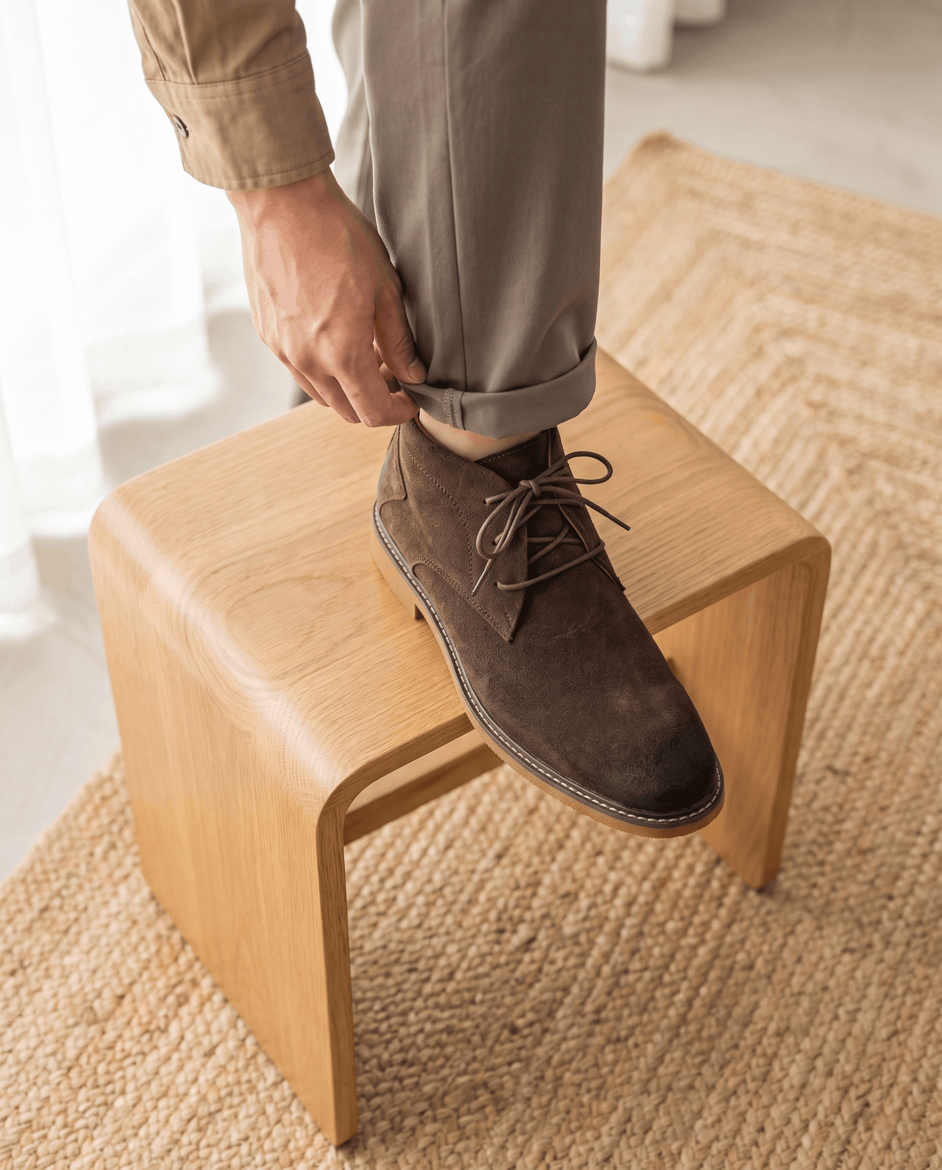 Dark brown vegan suede chukka boots with three-eyelet lacing, a stitched welt, and a flat rubber outsole.