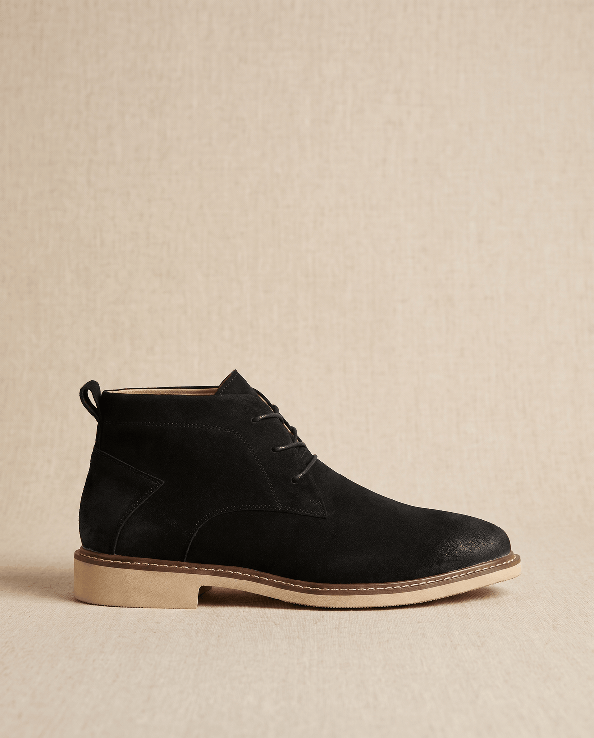 Black vegan suede chukka boots featuring a three-eyelet lace-up design, stitched welt, and a flat rubber outsole.