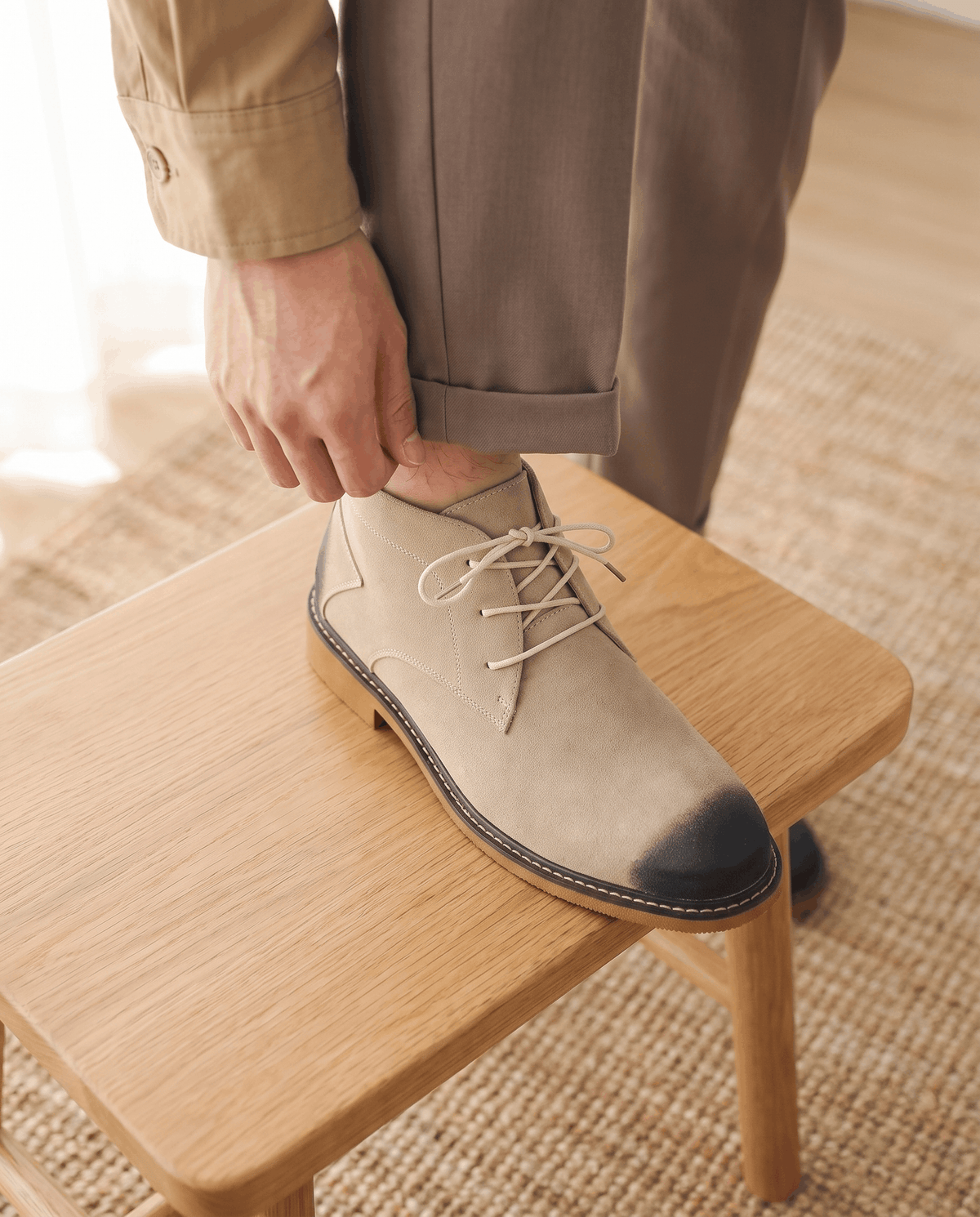 Beige vegan suede chukka boots with a three-eyelet lace-up design, dark toe detail, and a welted rubber outsole.